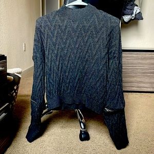 This is a light weight sweatshirt piece. It has zipper sleeves.